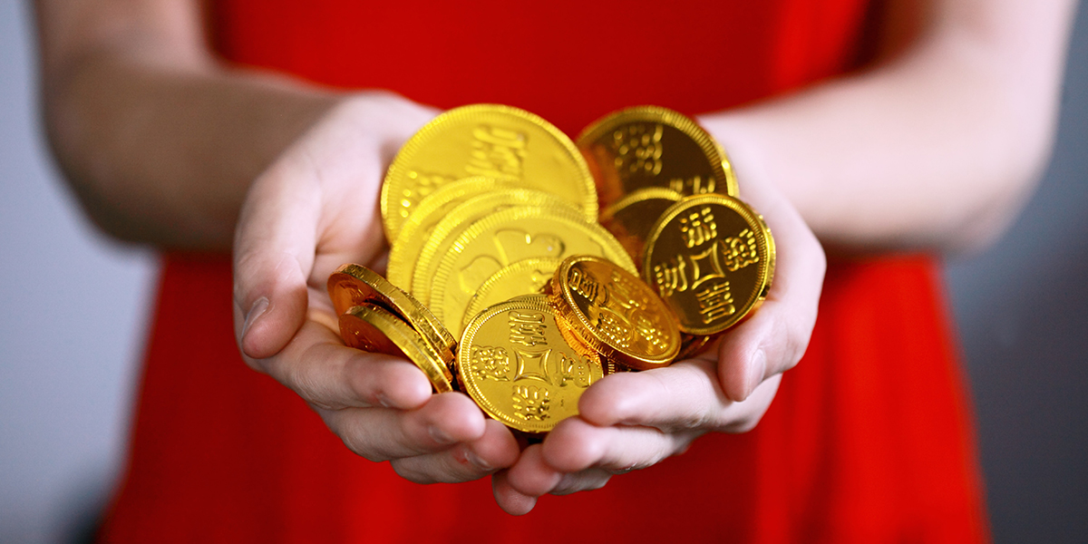 Woman in red dress holding yen.